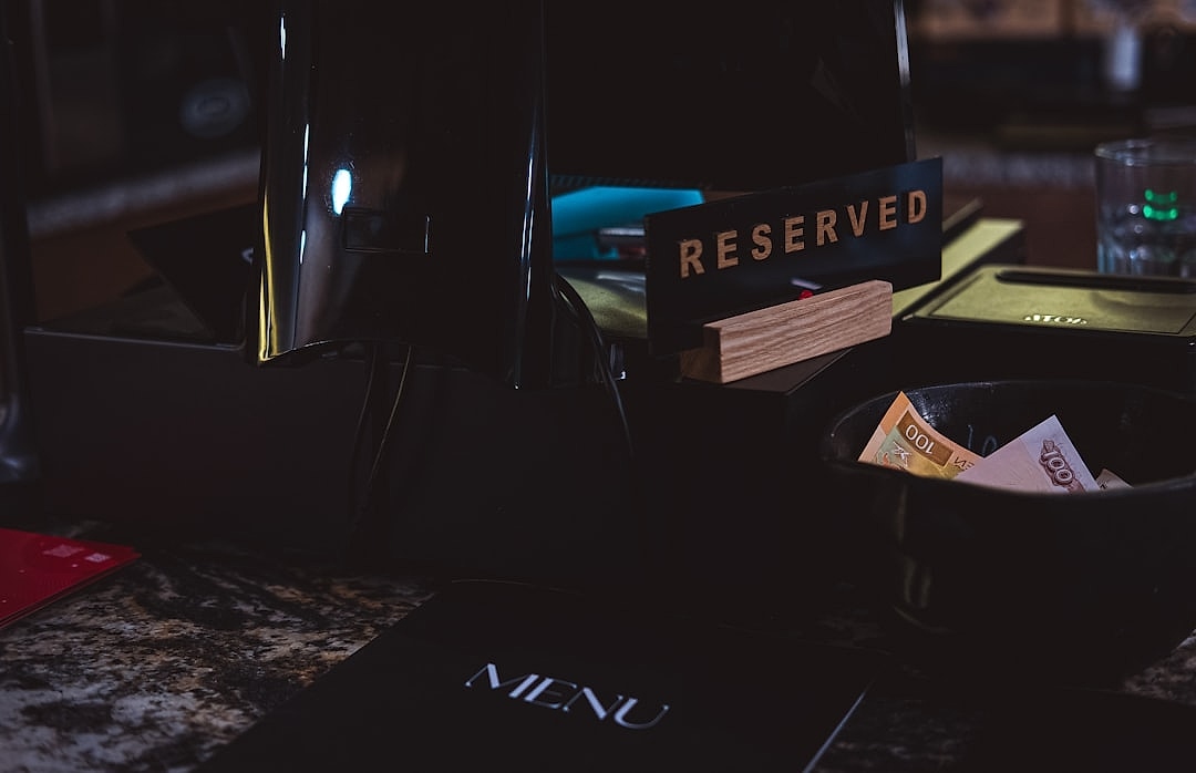 Refined restaurant onboarding materials on a wooden table.